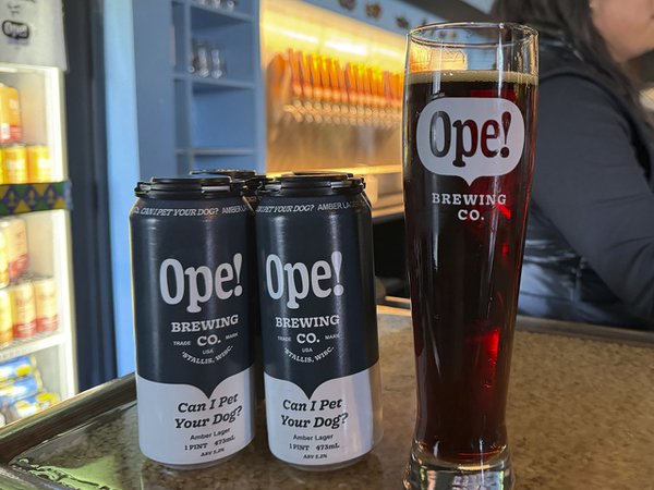 Ope! cans and a glass of beer on the Ope! bar.