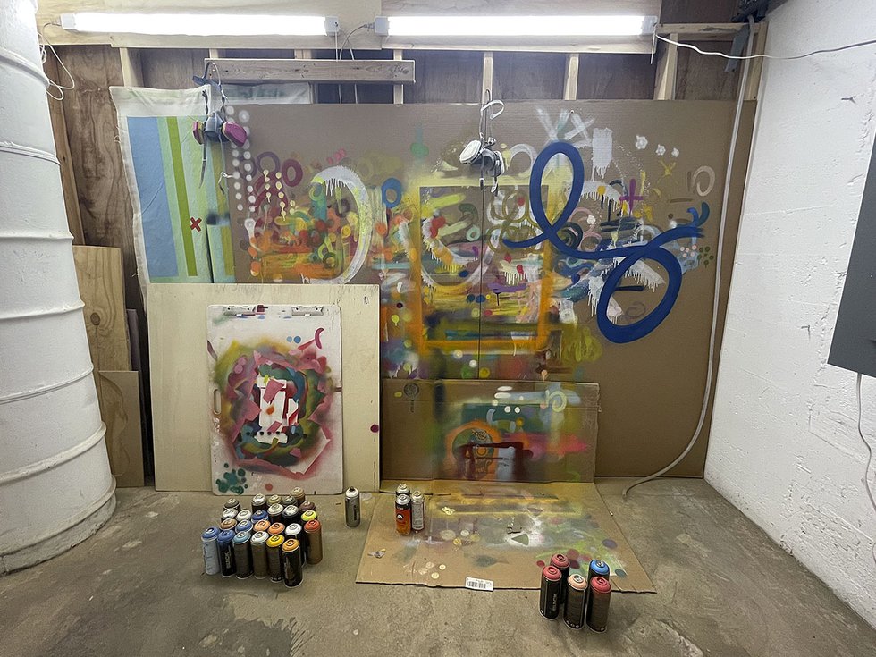 A spray paint practice wall in Liubóv Szwako's studio.