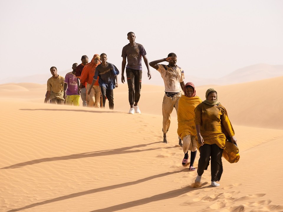 People walking through the desert.