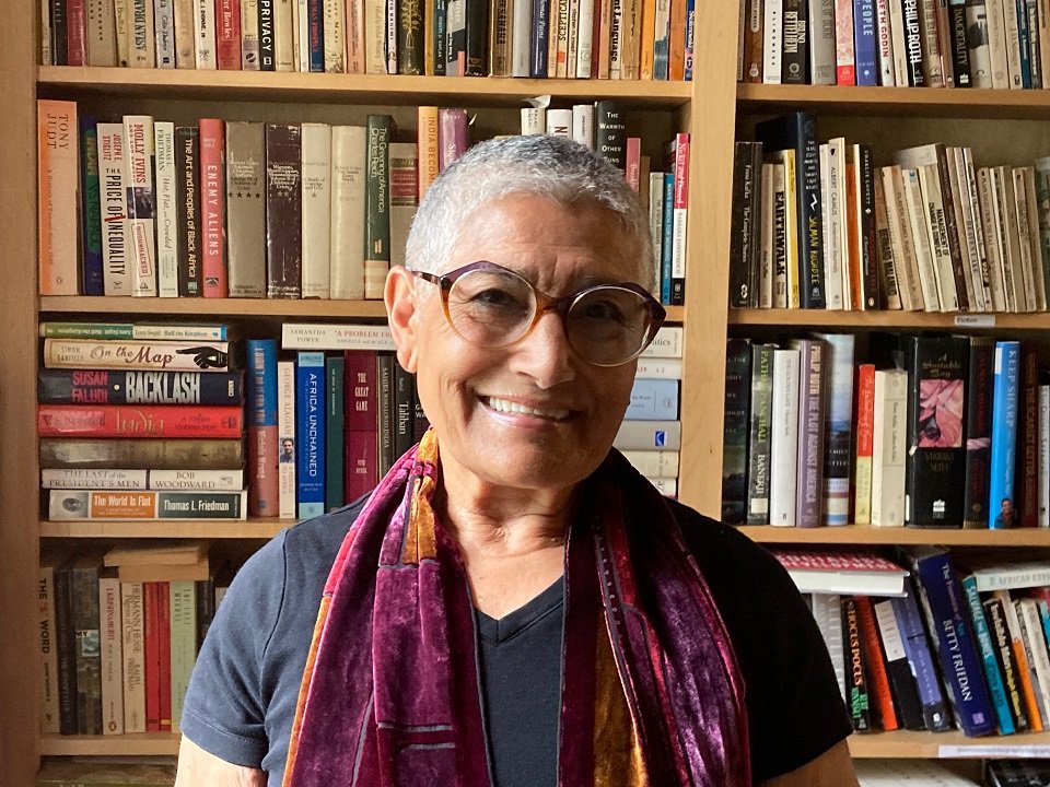 JK Cheema in front of a bookshelf.