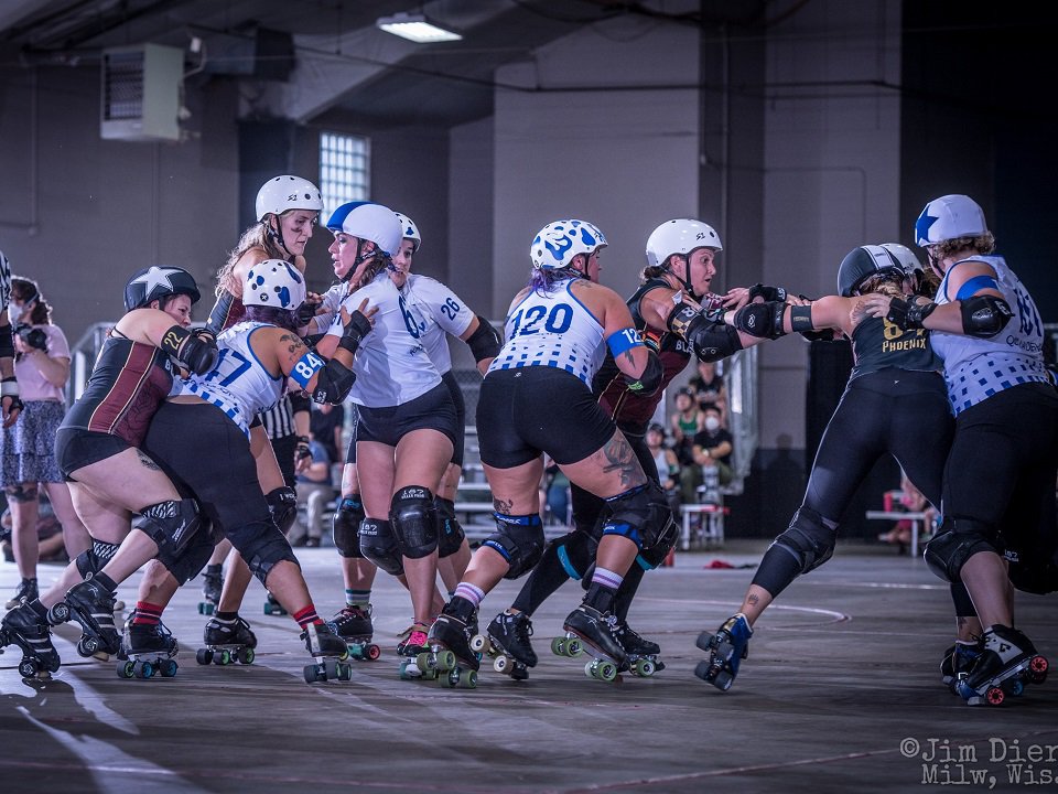 A bout during the 2023 Udder Chaos invitational hosted by Madison Roller Derby.
