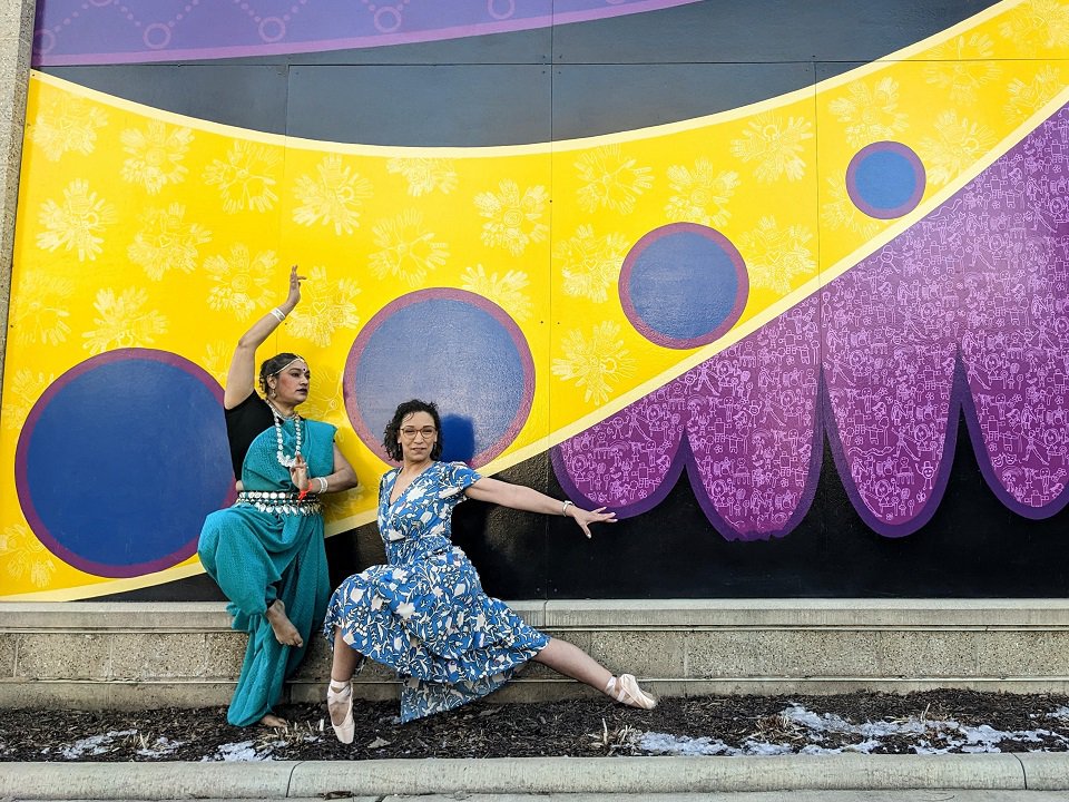 Choreographers Raka Bandyo (left) and Rachelle Fochs in front of a mural at Madison Youth Arts.