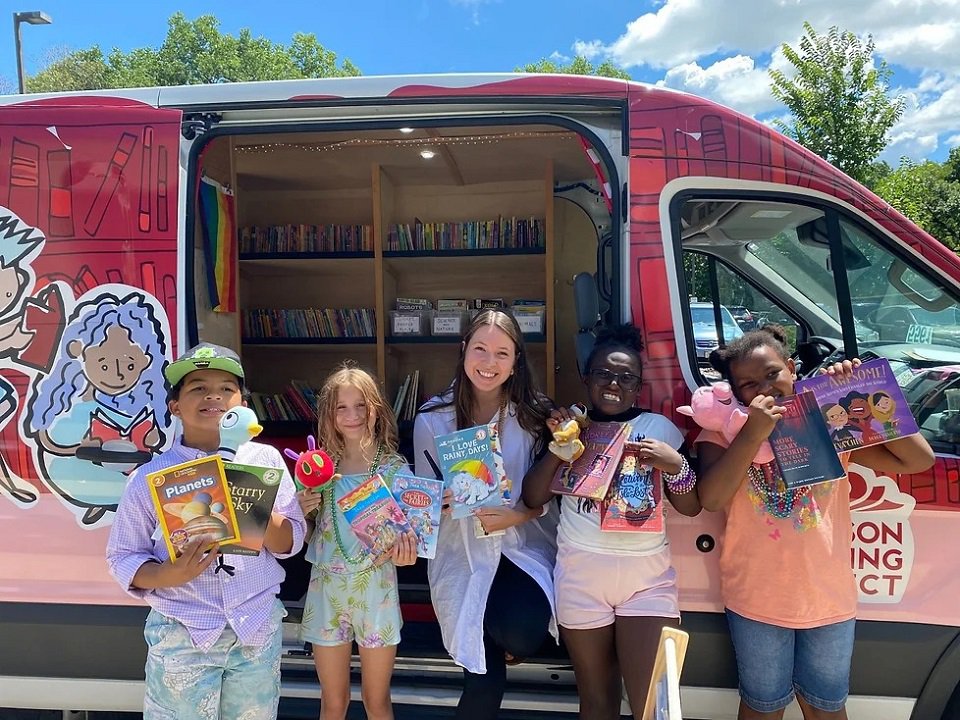 A Madison Reading Project book bus and readers.