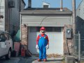 Mario in front of a garage.