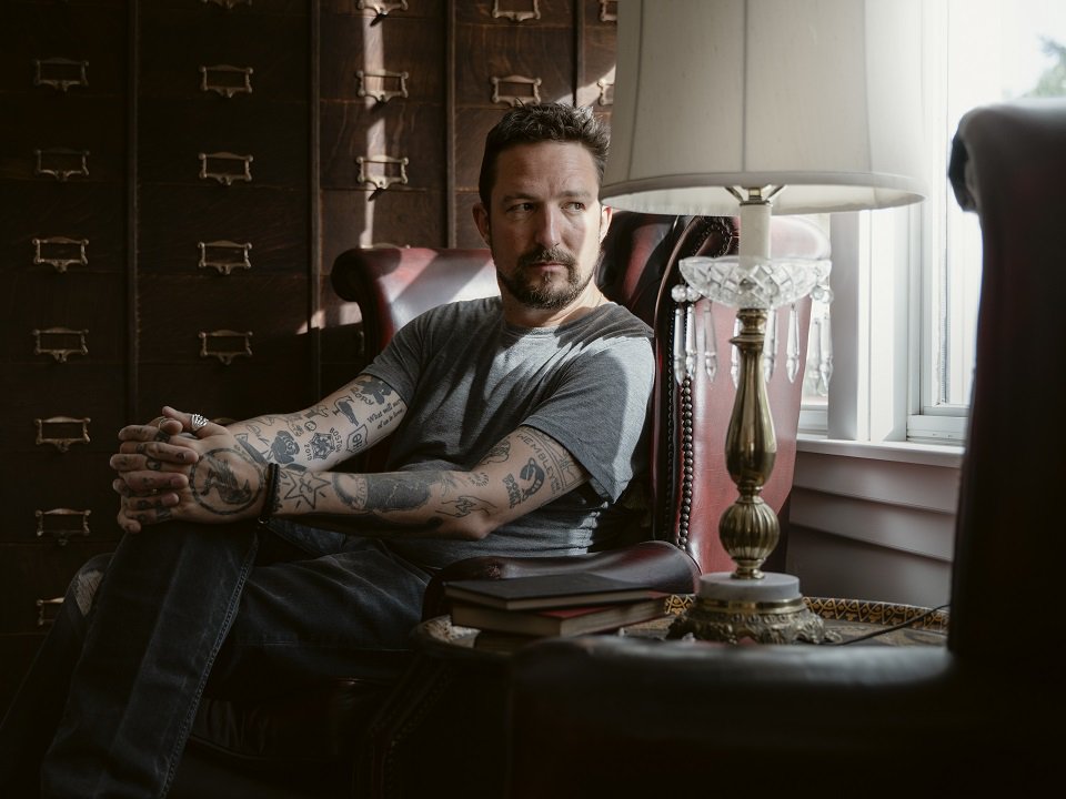 Frank Turner in a chair.