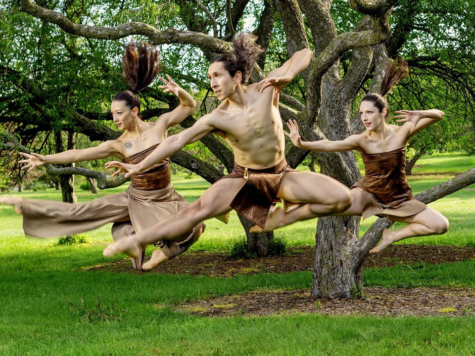 Three dancers in the woods.