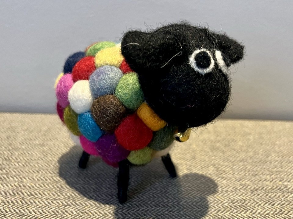 A sheep ornament made of felt.