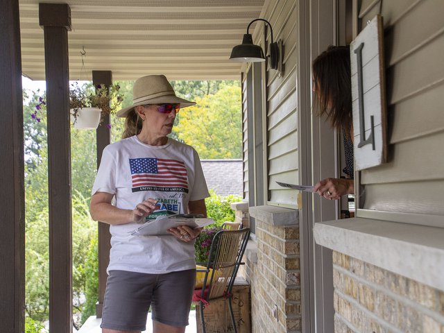 Elizabeth Grabe, the Democratic candidate for the 51st Assembly district, speaks with a potential voter while canvassing in Mount Horeb on Sept. 13, 2024.