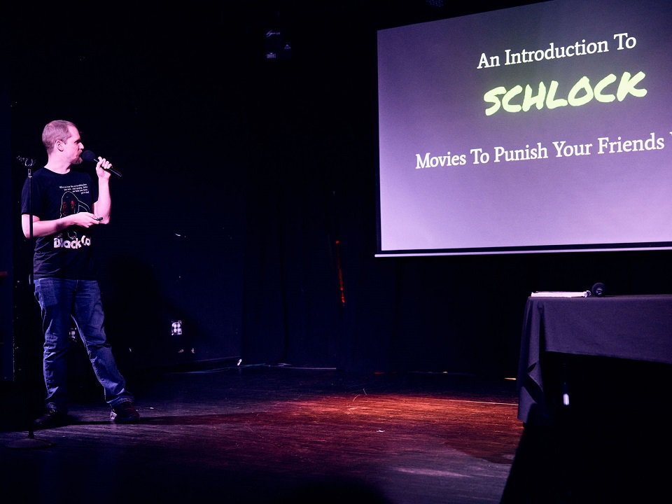 "Schlock and Awe" creator Cody Lemke on stage.