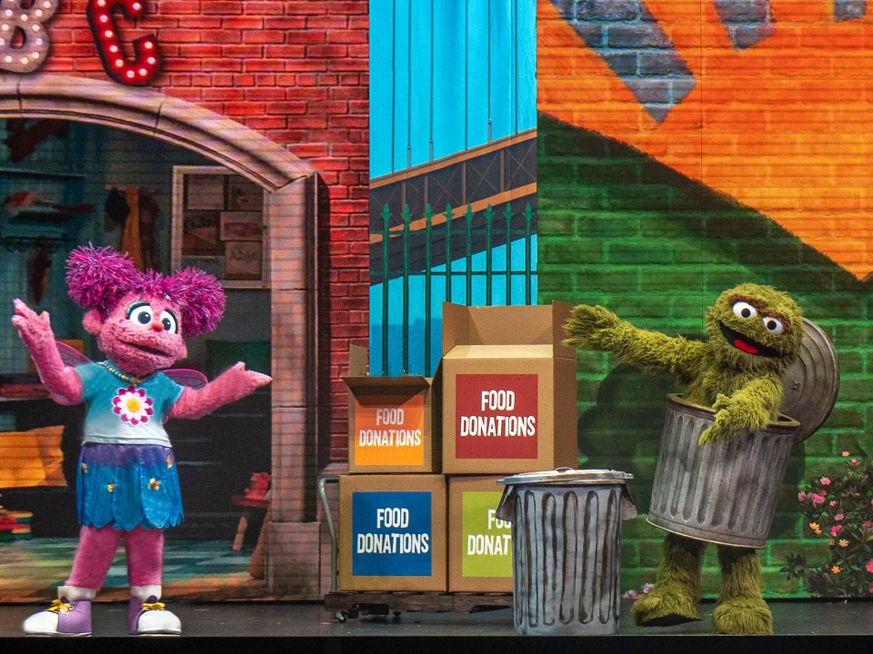 Sesame Street Live characters on stage.