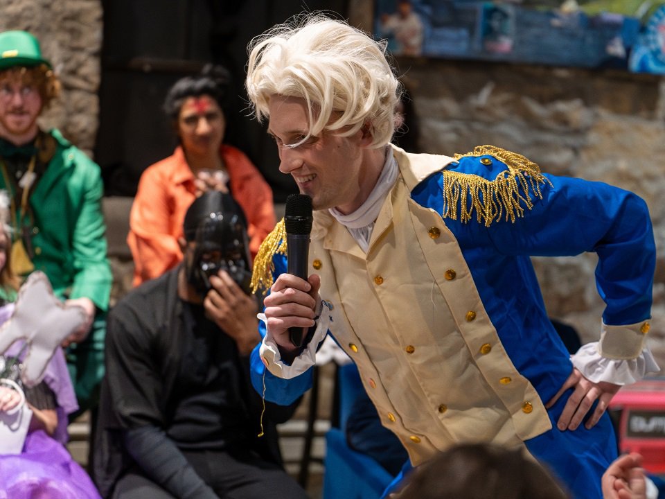 Noah Van Der Weide in costume during a past Cheshire Cat Comedy roast.