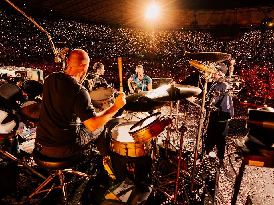 The four members of Coldplay on stage.