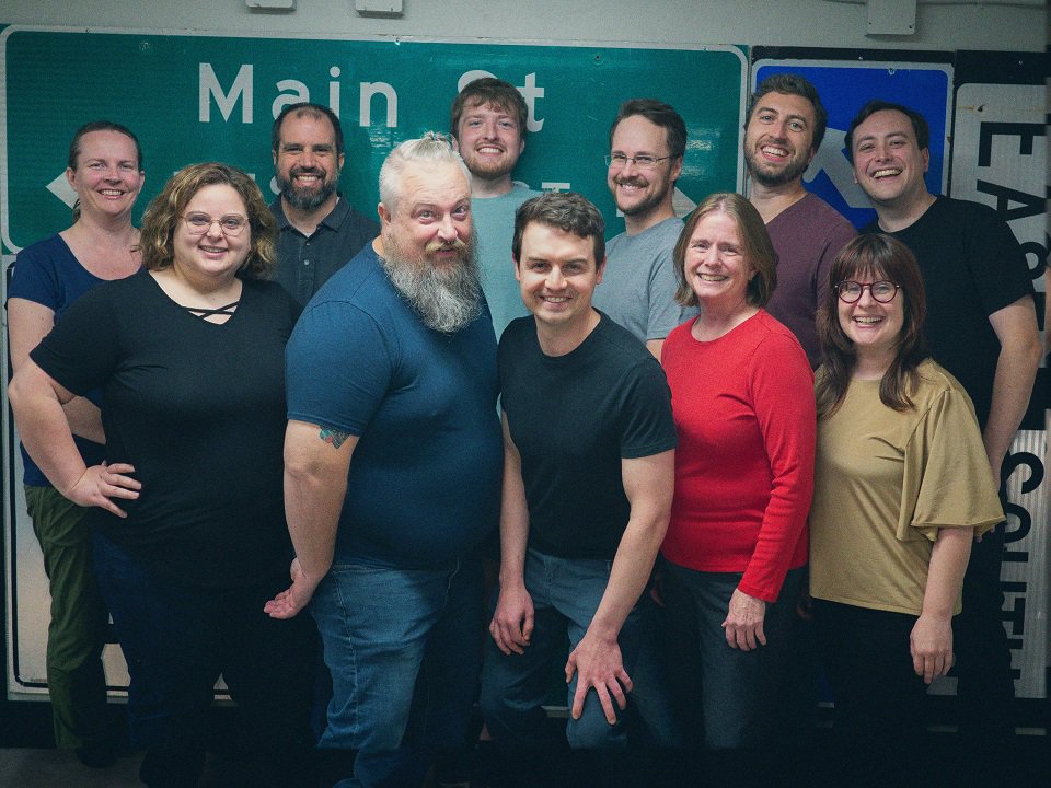 A group of smiling people pose for a photo.