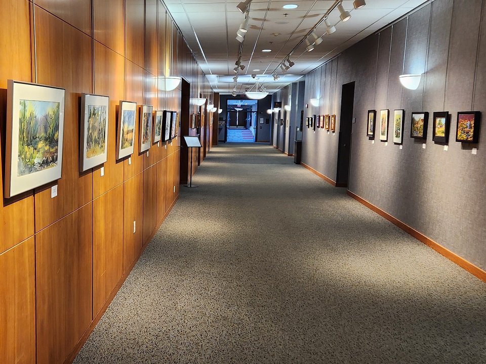 A hallway lined with paintings.