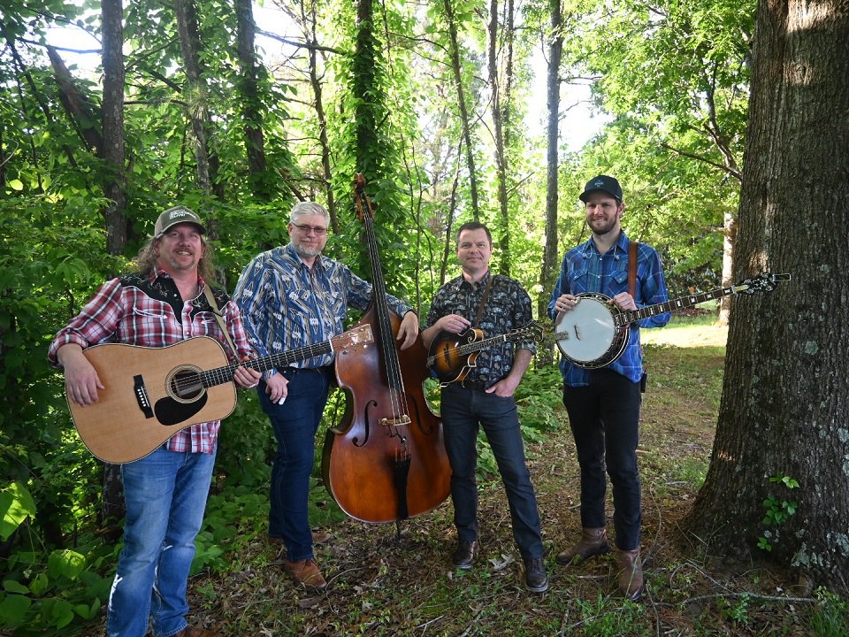 The four members of Full Cord in the woods.