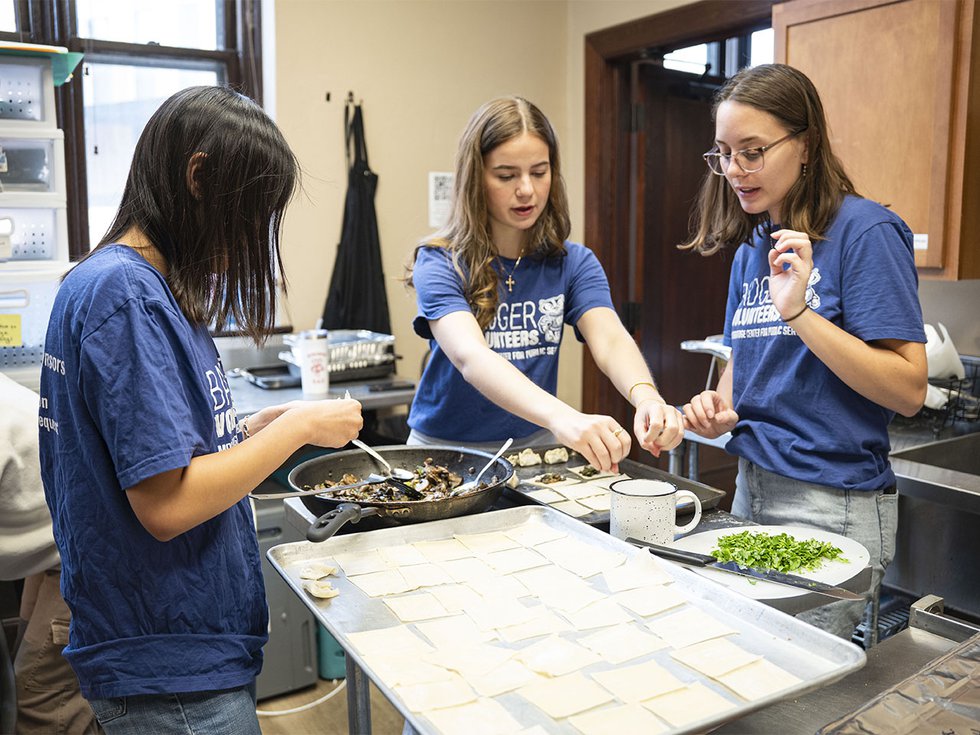 Badger Volunteers make dumplings at The Crossing.