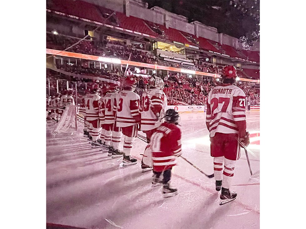 A young hockey fan visiting the UW hockey team.