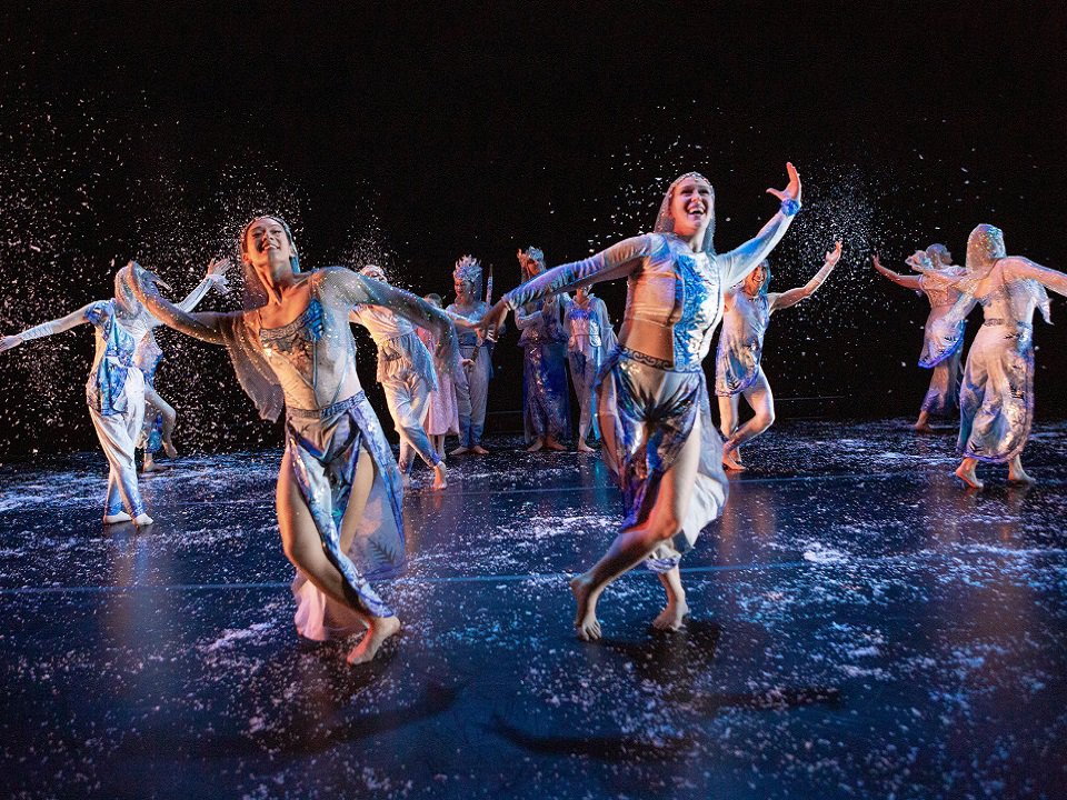 From Winter Fantasia, Kanopy Dance 2024, shows a half-dozen dancers in a scene like a  moonlit night wearing floaty costumes.