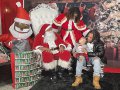 A family visits Santa at the Holiday Black Bazaar.