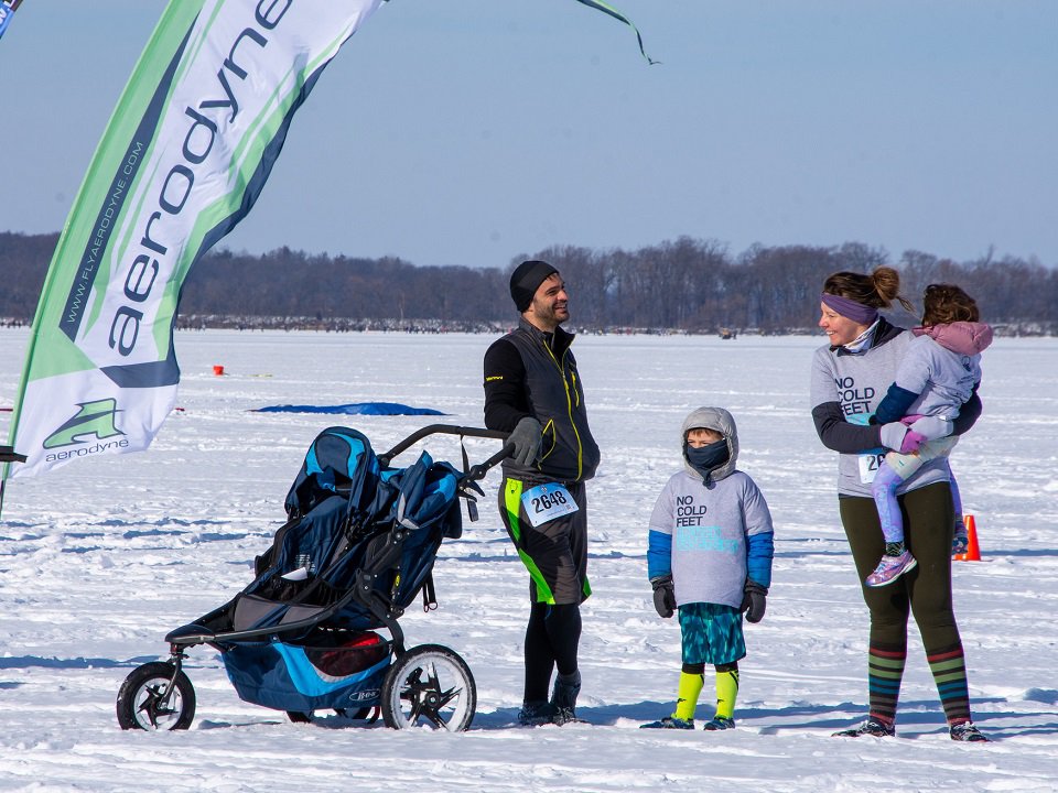 A family enjoys frozen Lake Mendota at a past Frozen Assets Festival.