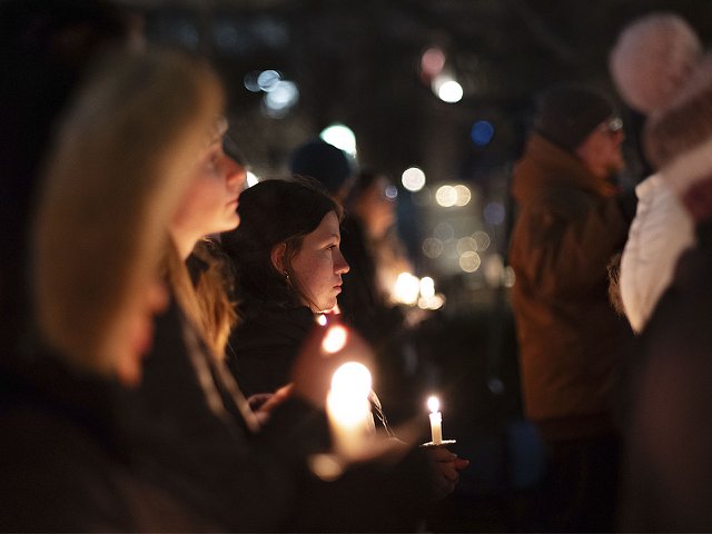 Gun violence vigil attendees holding candles.