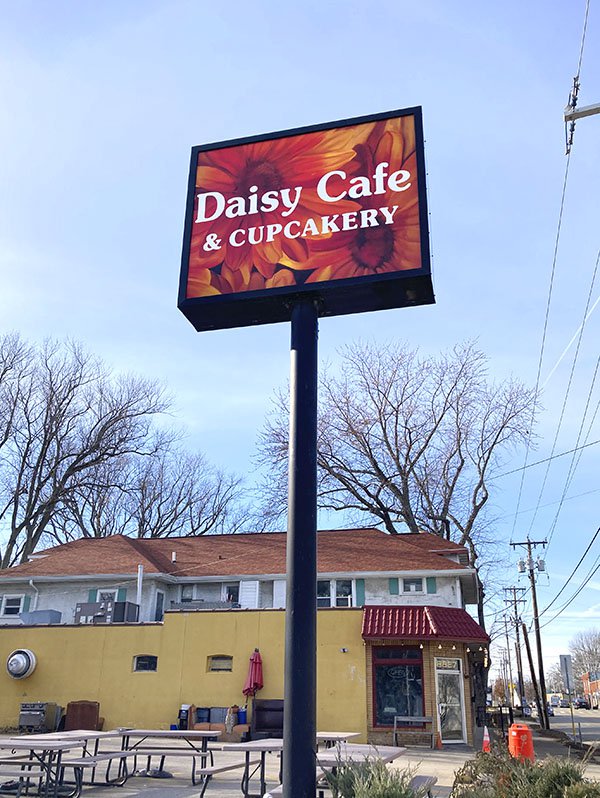 The sign outside Daisy Cafe &amp; Cupcakery.